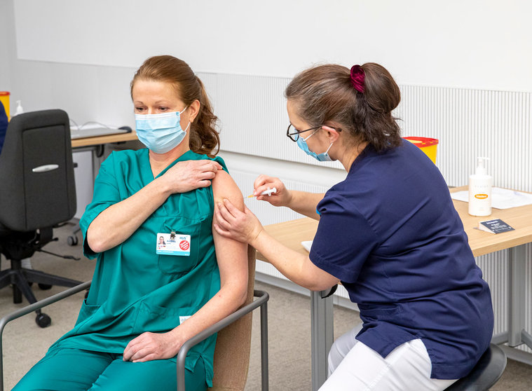 A healthcare worker gets vaccinated in Helsinki. Photo: @HUS/file photo.