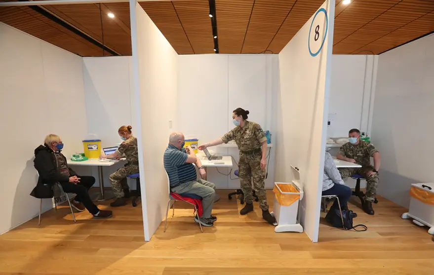 Michael Maddocks (left) and James Logan (right) receive their coronavirus vaccine in Edinburgh. More than 20 million people in Britain have received their first coronavirus vaccine dose, Health Secretary Matt Hancock said on Sunday, a figure that corresponds to about 30 per cent of the population. Photo: Andrew Milligan/PA Wire/dpa