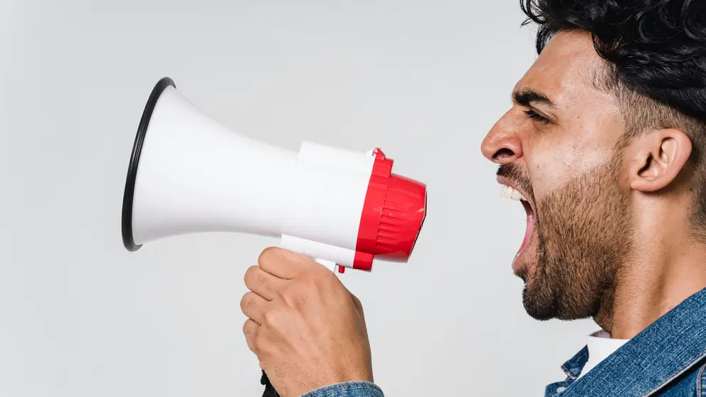 A man yells through a loudspeaker.
Photo: Sora Shimazaki/Pexels.