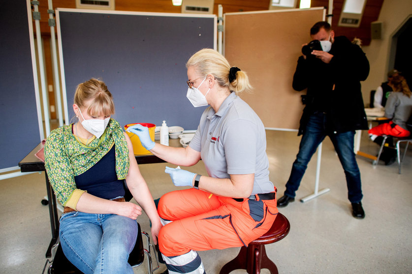 10 March 2021, Lower Saxony, Hanover: A woman receives her dose of the AstraZeneca COVID-19 vaccine at a vaccination centre. Photo: Hauke-Christian Dittrich/dpa