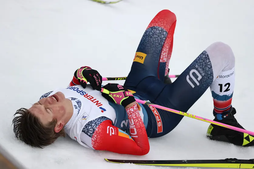 07 March 2021, Bavaria, Oberstdorf: Norway's Johannes Hoesflot Klaebo lies on teh ground after crossing the finish of the men's 50 kilometre classical mass start event at the FIS Nordic World Ski Championships in Oberstdorf. Photo: Daniel Karmann/dpa