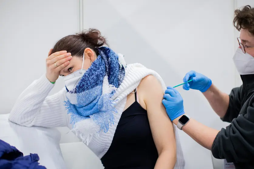 08 March 2021, North Rhine-Westphalia, Cologne: Bianca Ahlemeier, a childminder in home daycare, reacts as she receive her AstraZeneca's COVID-19 vaccine dose at a vaccination centre. Photo: Rolf Vennenbernd/dpa