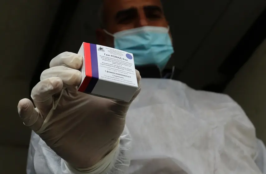 17 February 2021, Palestinian Territories, Rafah: A Palestinian health worker holds a pack of the Sputnik V COVID-19 vaccine. The Gaza Strip received its first batch of the Sputnik V COVID-19 vaccine on Wednesday. Photo: Ashraf Amra/APA Images via ZUMA Wire/dpa