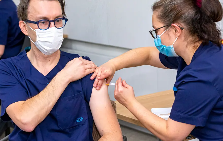 A health worker gets a vaccine dose in Helsinki. Photo: @HUS.