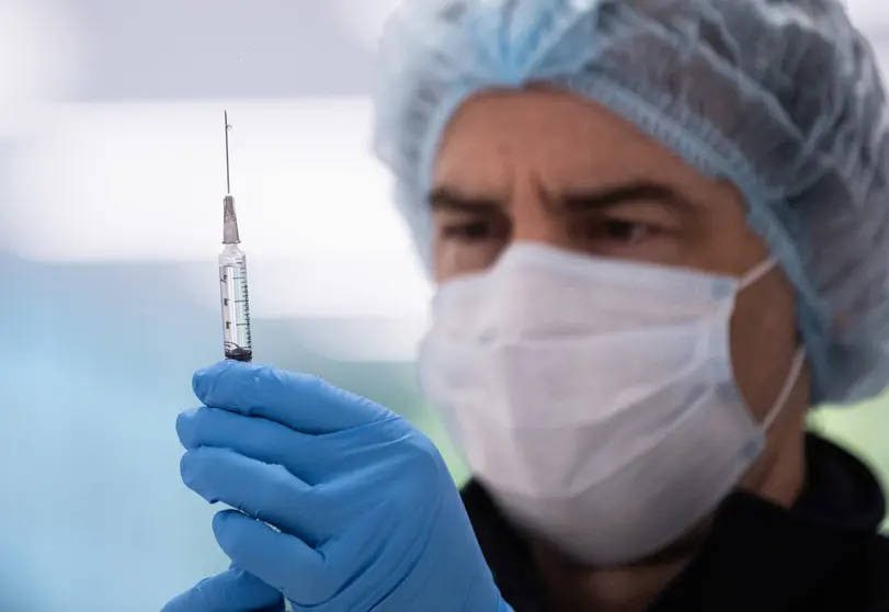 10 May 2021, Australia, Sydney: A health worker prepares a syringe with coronavirus (COVID-19) vaccine in the pharmacy area of the New South Wales (NSW) Vaccination Centre in Homebush. The hub will be open to people in categories 1a and 1b before expanding to anyone over 50 from May 24. Photo: James Gourley/NCA NEWSWIRE POOL via AAP/dpa