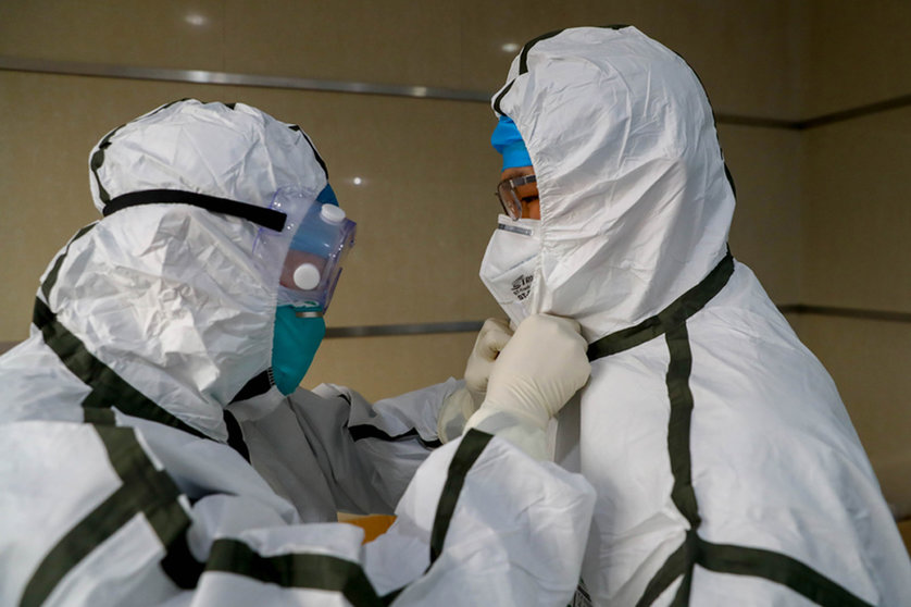 FILED - Medical staff put on their protective suits at a hospital in Wuhan, ground zero for the coronavirus outbreak. China rejected US President Joe Biden's order for a new investigation by US intelligence agencies into the origins of the coronavirus, accusing the US of trying to politicize the search. Photo: -/TPG via ZUMA Press/dpa