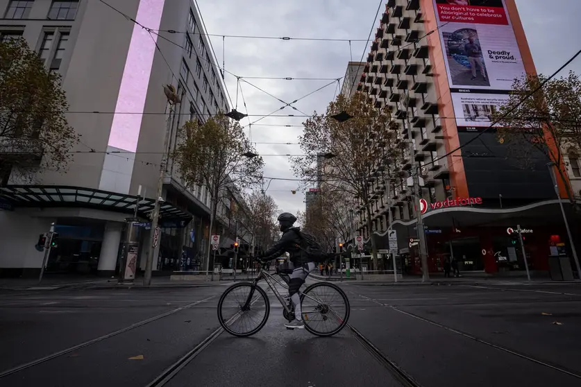 09 June 2021, Australia, Melbourne: A cyclist crosses a quiet Bourke Street. Melbourne will exit a COVID-19 lockdown as planned on Thursday night, but some restrictions on travel and gatherings would apply for another week. Photo: Daniel Pockett/AAP/dpa