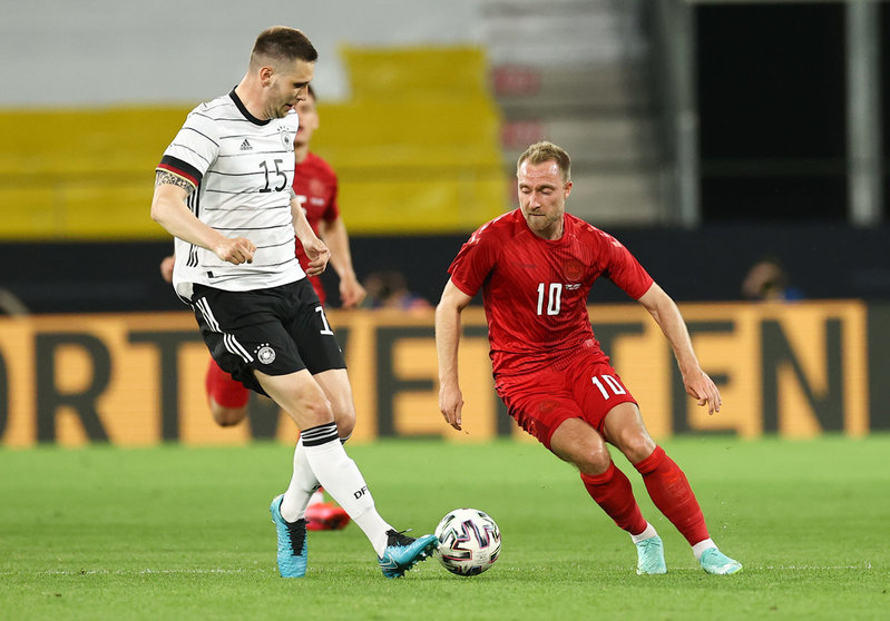 02 June 2021, Austria, Innsbruck: Germany's Niklas Suele (L) and Denmark's Christian Eriksen fight for the ball during the International Friendly soccer match between Germany and Denmark at Tivoli Stadium. Photo: Christian Charisius/dpa