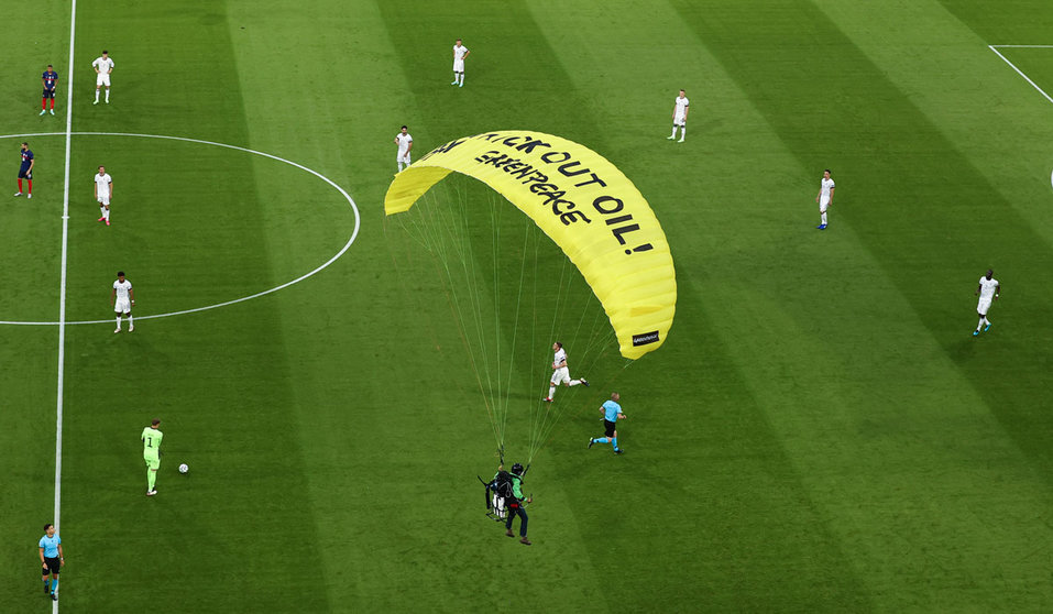 15 June 2021, Bavaria, Munich: A Greenpeace activist lands on the pitch before the start of the UEFA EURO 2020 Group F soccer match between France and Germany at the Allianz Arena. Photo: Christian Charisius/dpa