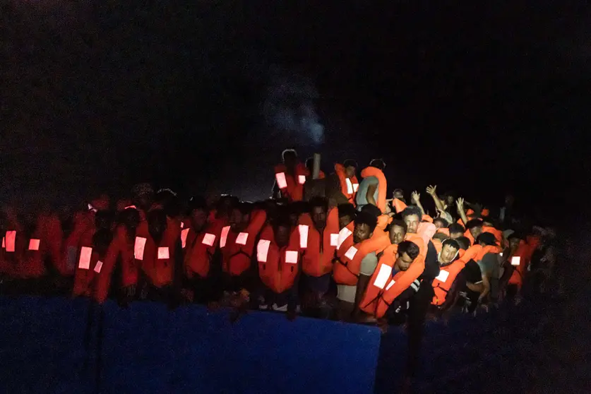 HANDOUT - 05 July 2021, ---, Mediterranean Sea: Numerous refugees are crowded together on a boat at night. The private sea rescuers of the ship Ocean Viking have rescued several hundred boat migrants in the central Mediterranean Sea in a major operation. The crew took a total of almost 370 people on board from a wooden boat in Libyan waters on Monday night, SOS Mediterranee announced on Monday morning. Photo: Flavio Gasperini/SOS Mediterranée/dpa -