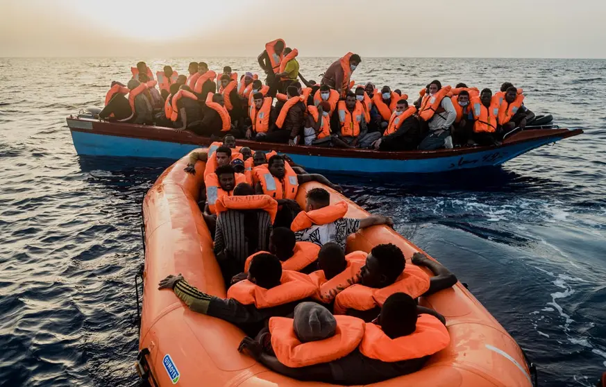 HANDOUT - 04 July 2021, Italy, ---: Migrants sit in a small boat and a rubber dinghy in the Mediterranean Sea. The Ocean Viking rescue vessel has pulled 67 people from the central Mediterranean Sea, SOS Mediterranee the private organization that runs the vessel, said on Sunday. Photo: Flavio Gasperini/SOS Mediterranee/dpa - ATTENTION: editorial use only and only if the credit mentioned above is referenced in full