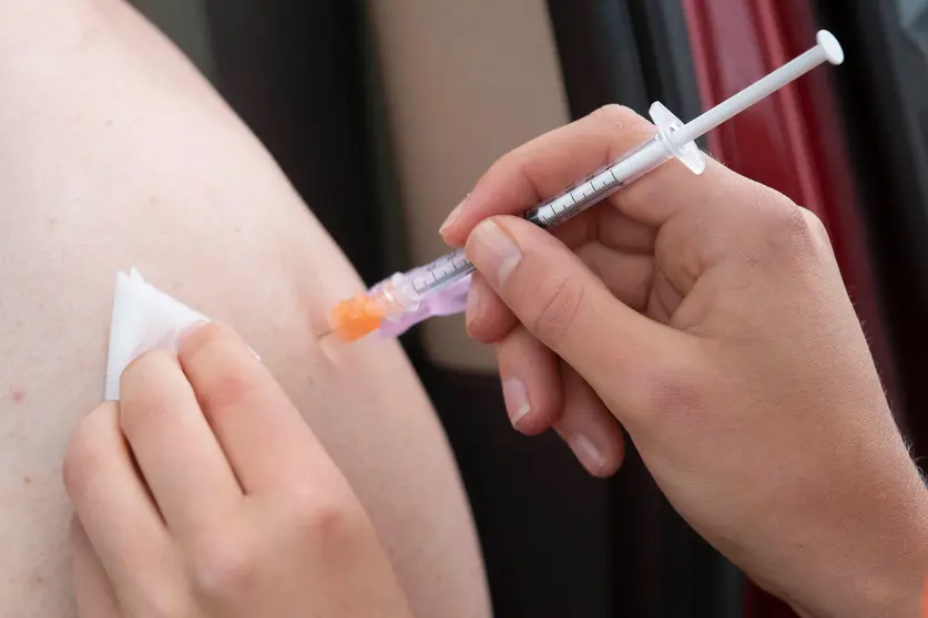 02 July 2021, Canada, Kingston: A person receives their COVID-19 vaccine during a drive-thru clinic at Richardson stadium. Photo: Lars Hagberg/The Canadian Press via ZUMA/dpa