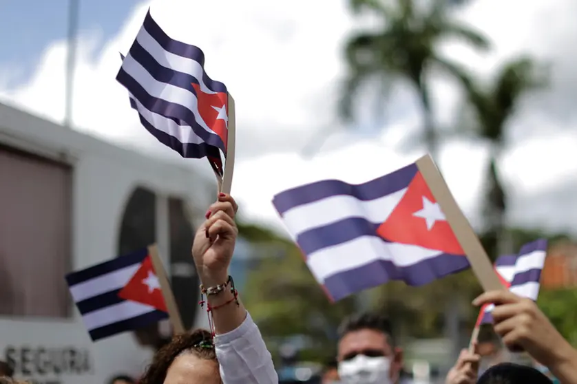 FILED - Demonstrators wave flags of Cuba during a rally in front of the Cuban Embassy in support of the island's government. Scores of people had demonstrated the day before in Havana and several other Cuban cities against the economy of scarcity and oppression. Observers spoke of the largest demonstrations in Cuba in decades. Photo: Jesus Vargas/dpa