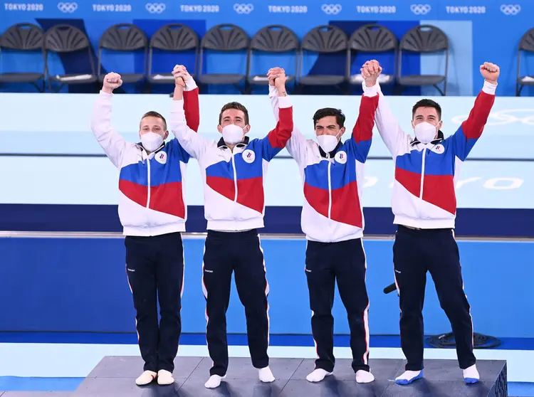 26 July 2021, Japan, Tokyo: Russian Olympic Committee's (ROC) gold medallists, Denis Abliasin, David Belyavsky, Artur Dalaloyan and Nikita Nagorny celebrates on the podium during the medal ceremony of the artistic gymnastic men's team final at the Ariake Gymnastics Centre, part of the Tokyo 2020 Olympic Games. Photo: Marijan Murat/dpa