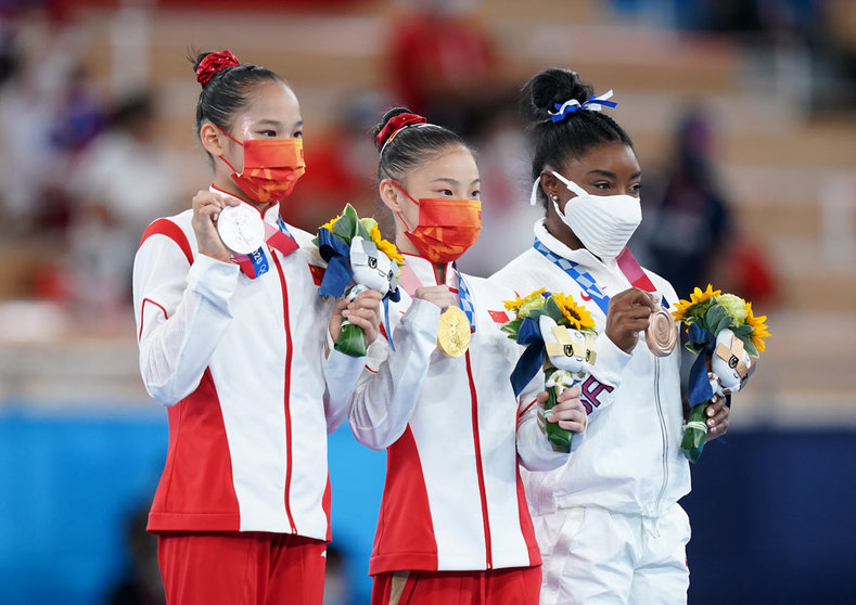 03 August 2021, Japan, Tokyo: (L-R) Silver medallist China's Xijing Tang, gold medallist China's Chenchen Guan, and bronze medallist USA's Simone Biles celebrate their medals at the award ceremony for the Women's Balance Beam Final of the Artistic Gymnastics competition at the Ariake Gymnastics Centre during the Tokyo 2020 Olympic Games. Photo: Mike Egerton/PA Wire/dpa