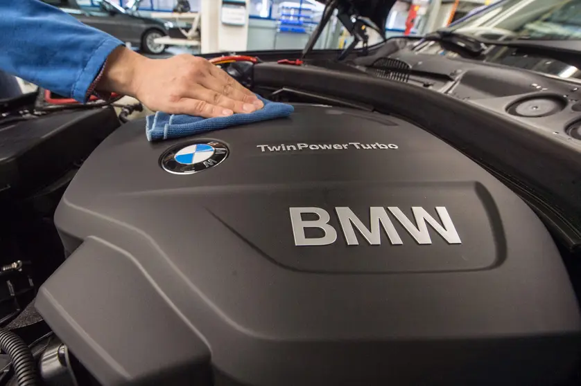 FILED - 13 March 2015, Bavaria, Regensburg: A staff member polishes the engine of a BMW car model at the assembly plant of car manufacturer BMW in Regensburg. The international shortage of microchips means German carmaker BMW will temporarily stop production at its facility in Regensburg, according to a company spokesperson on Sunday. Photo: picture alliance / dpa