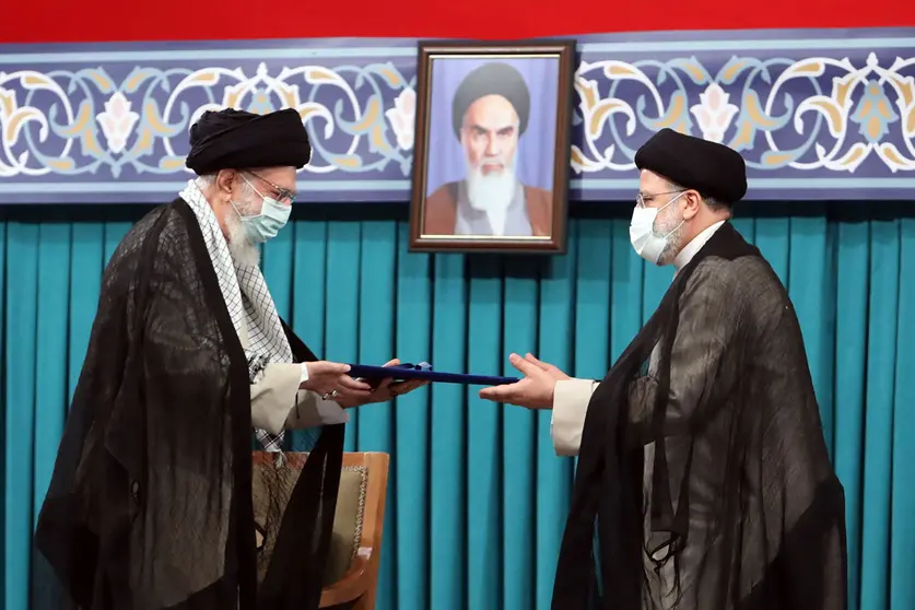 HANDOUT - Iranian supreme leader Ayatollah Ali khamenei (L) , gives his official seal of approval to newly elected President Ebrahim Raisi during the latter's inauguration ceremony at the office of the supreme leader. Photo: -/Iranian Supreme Leader's Office/dpa - ATTENTION: editorial use only and only if the credit mentioned above is referenced in full