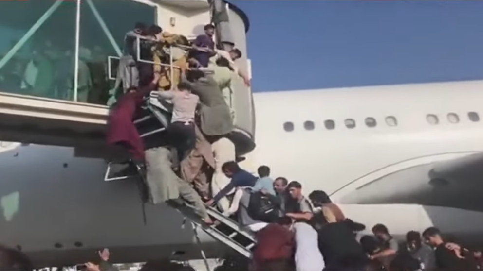 Afghans crowd a staircase trying to board a plane to leave the country. Image: YouTube/screenshot.