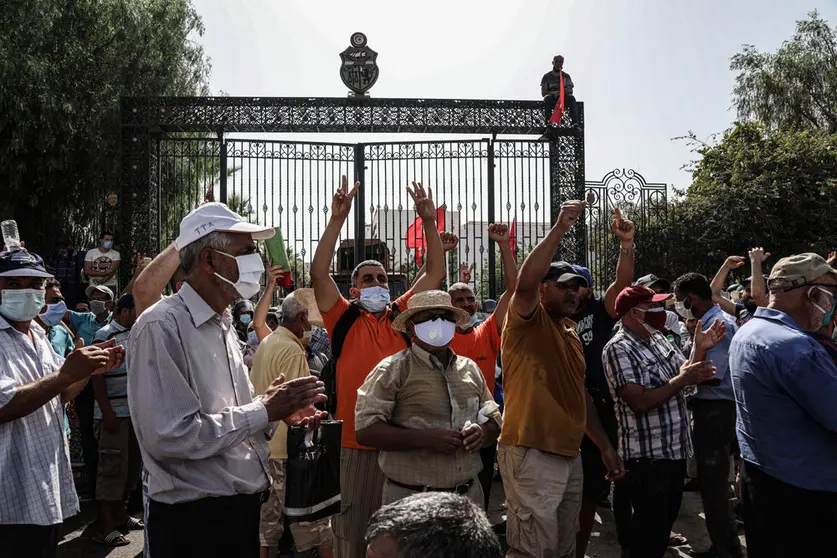 26 July 2021, Tunisia, Tunis: Supporters of Tunisian President Kais Saied chant slogans during a protest in front of the Parliament building, denouncing Rached Ghannouchi, Parliament Speaker and President of the Islamist Ennahda Movement, after President Saied sacked the prime minister and suspended the parliament the night before. Photo: Khaled Nasraoui/dpa