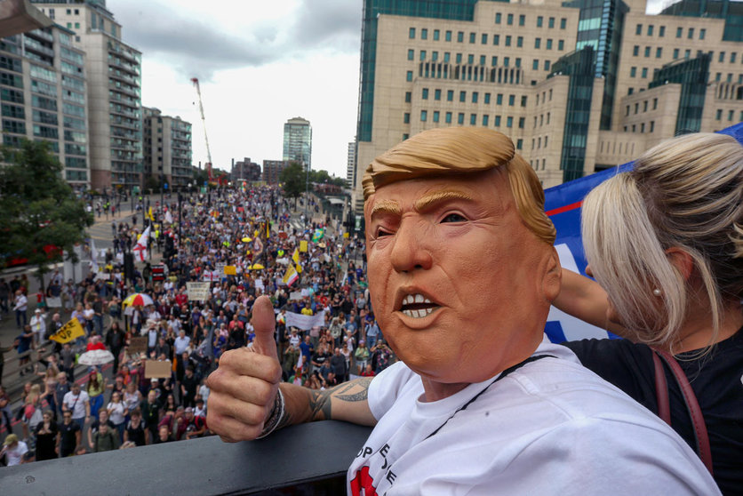 28 August 2021, United Kingdom, London: A protester wears a Donald Trump mask, during the medical freedom march against Vaccine passports, mandatory vaccines for care workers and vaccines for children. Photo: Martin Pope/SOPA Images via ZUMA Press Wire/dpa