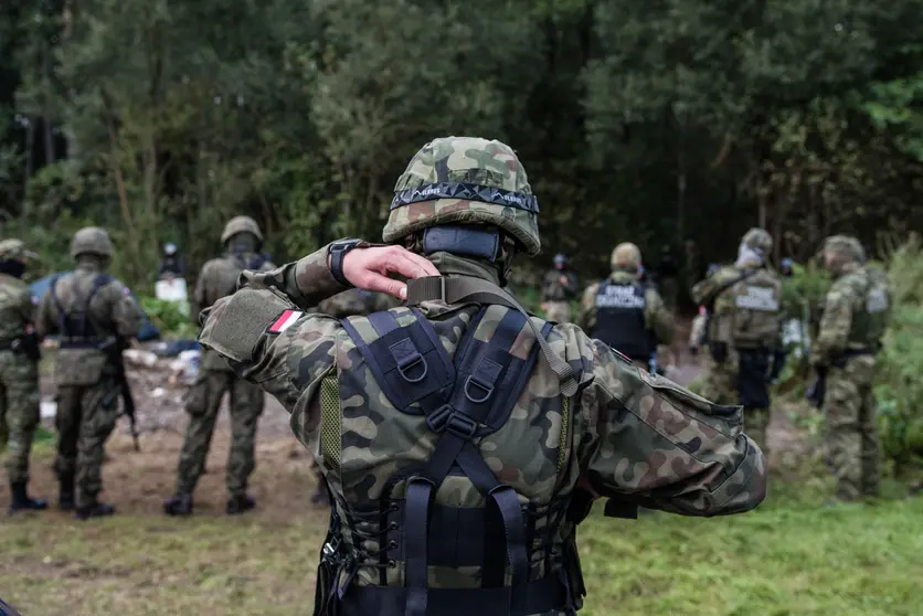 19 August 2021, Poland, Usnarz Gorny: Polish Border guards stand guarding the Afghan refugees stuck at the Polish-Belarusian border. Photo: Attila Husejnow/SOPA Images via ZUMA Press Wire/dpa