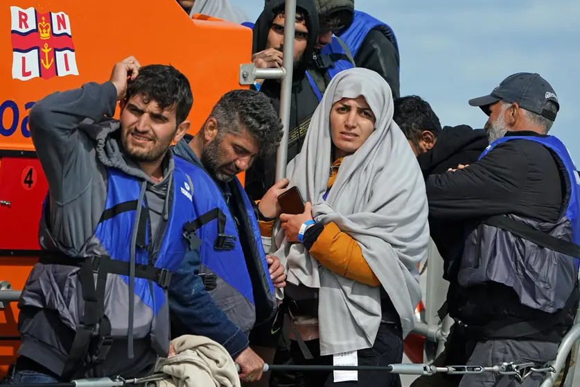 13 September 2021, United Kingdom, Dungeness: A group of people thought to be migrants are brought in to Dungeness, Kent, by the RNLI, following a small boat incident in the Channel. Photo: Gareth Fuller/PA Wire/dpa