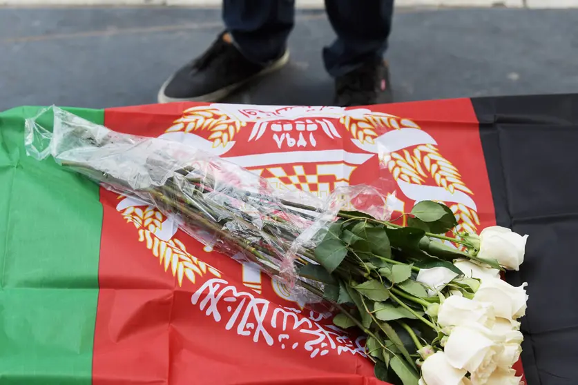 07 October 2021, US, Washington: Flowers seen on an Afghan flag during a demonstration demanding no more drone attacks on Afghanistan during a rally marking the 20th Anniversary of the US attack on Afghanistan at Raytheon Headquarters. Photo: Lenin Nolly/SOPA Images via ZUMA Press Wire/dpa