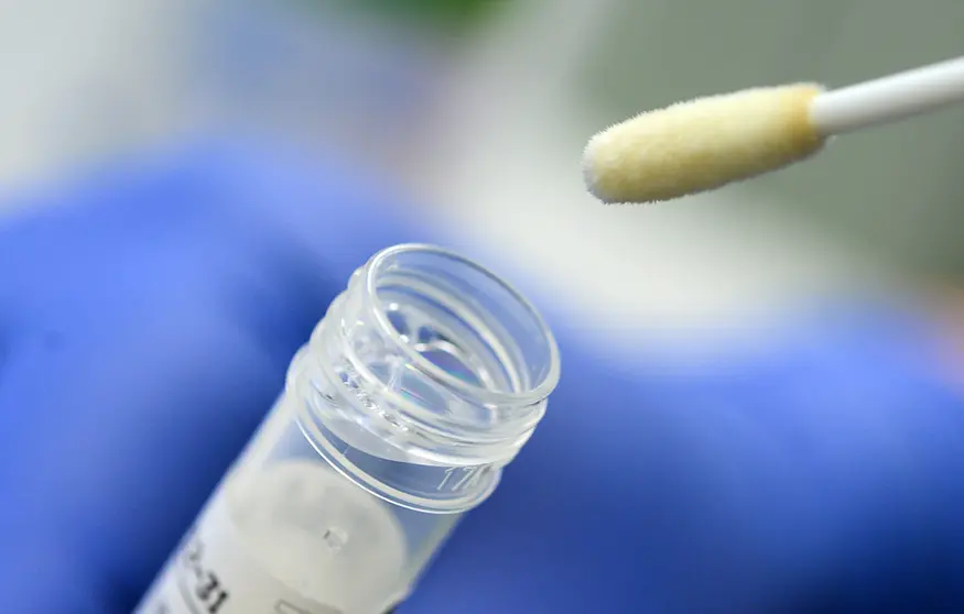 FILED - A man shows his Covid testing bud. British coronavirus rules have been relaxed for returning holidaymakers who are fully vaccinated in what the government is hailing a “huge boost” for the travel industry. Photo: Sebastian Gollnow/dpa