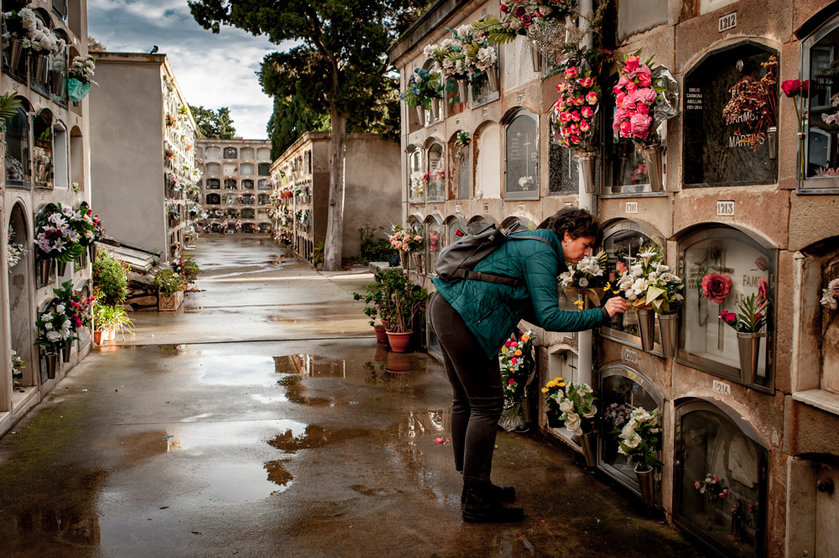 01 November 2021, Spain, Barcelona: A woman places a flower on the grave where her relatives rest at the Poblenou cemetery on All Saints Day, a Catholic holiday dedicated to the memory of the deceased. Photo: Jordi Boixareu/ZUMA Press Wire/dpa.