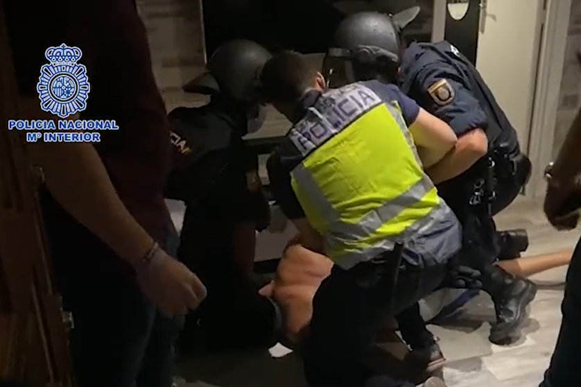 Police officers at the time of arrest. Image: screenshot from Police video.