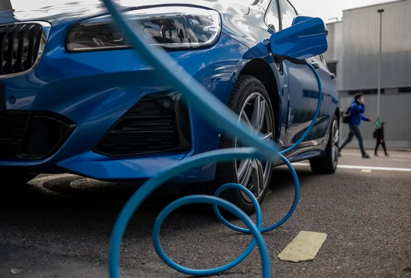 FILED - An electric car charges up at a BMW site in Leipzig, Germany. BMW chairperson Oliver Zipse on Wednesday warned that setting a date for the end of petrol and diesel cars could in fact harm the climate. Photo: Hendrik Schmidt/dpa-Zentralbild/ZB