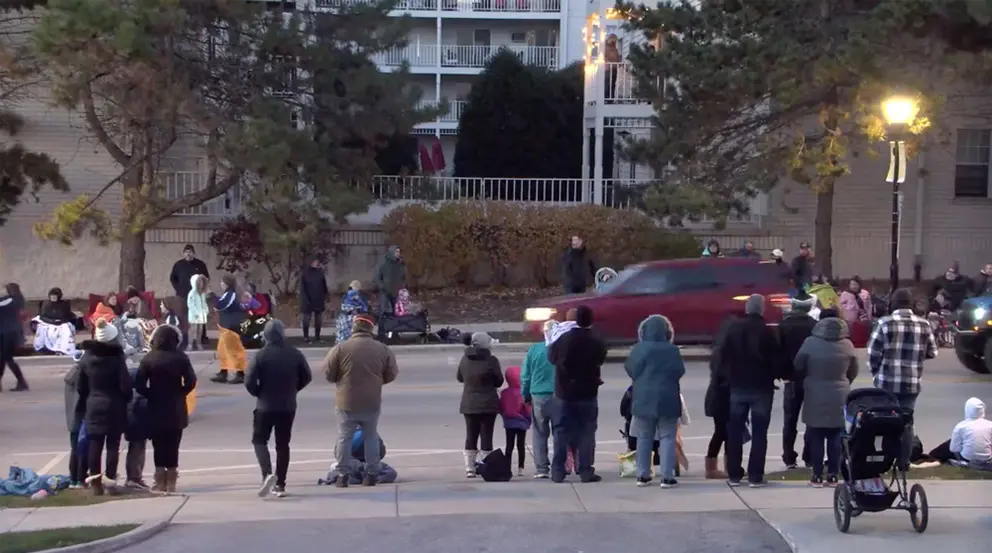 21 November 2021, US, Waukesha: An image captured from a video posted by the City of Waukesha on Facebook shows a red vehicle speeding through the Waukesha Christmas parade in Wisconsin. Several people were dead and dozens injured. Photo: -/TNS via ZUMA Press Wire/dpa.