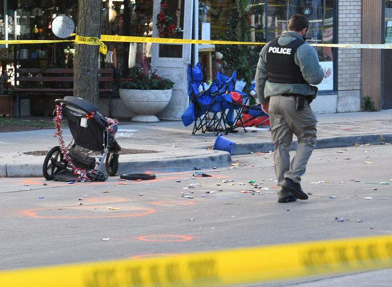 FILED - A police officer investigates the scene in downtown Waukesha after a SUV vehicle plowed into the Waukesha Christmas parade in Wisconsin. Several people were dead and dozens injured. Photo: Mark Hertzberg/ZUMA Press Wire/dpa.