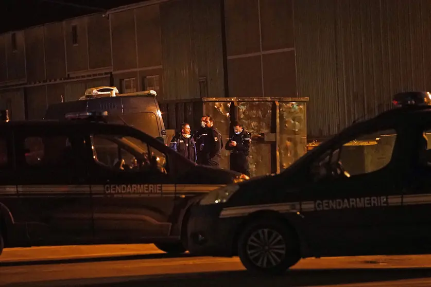 Gendarmes outside a warehouse in the Port of Calais, France, where it is believed the bodies of migrants are being transported after recovery from a boat which capsized off the French coast with the loss of 31 lives on Wednesday. An emergency search was sparked when a fishing boat sounded the alarm after spotting several people in the sea off the coast of France. Authorities found 31 bodies and two survivors while one person was missing. Picture date: Wednesday November 24, 2021. Photo: Stefan Rousseau/PA Wire/dpa.