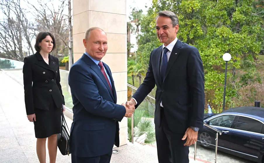 HANDOUT - 08 December 2021, Russia, Sochi: Russian President Vladimir Putin (L) welcomes Greek Prime Minister Kyriakos Mitsotakis at the Black Sea resort of Sochi. Photo: -/Kremllin/dpa - ATTENTION: editorial use only and only if the credit mentioned above is referenced in full.