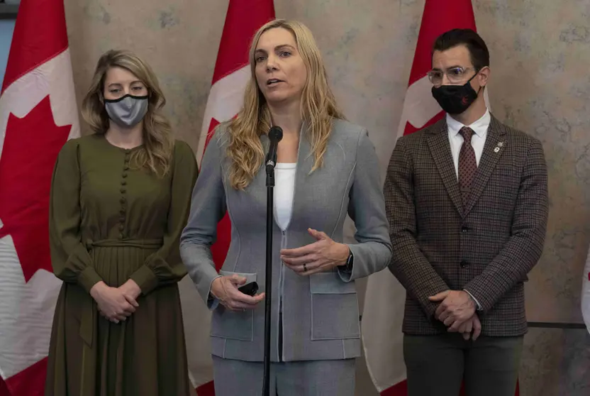 08 December 2021, Canada, Ottawa: Canada's Foreign Affairs Minister Melanie Joly (L) and former Olympic medalist and Liberal MP for Milton Adam van Koeverden listen to Canada's Minister of Sport Pascale St-Onge as she talks about a diplomatic boycott of the Winter Games in China. Photo: Adrian Wyld/The Canadian Press via ZUMA/dpa.