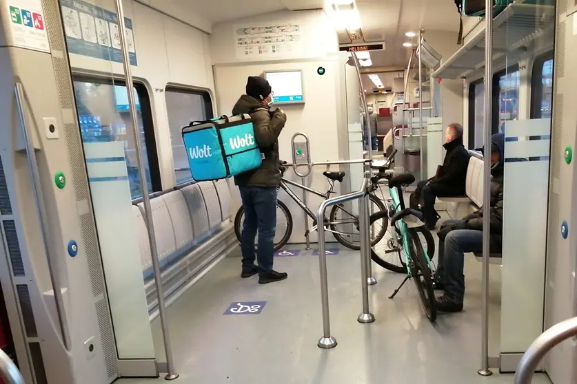 Wolt deliverymen, with their bicycles inside a train in Helsinki. Photo: The Nomad Today.