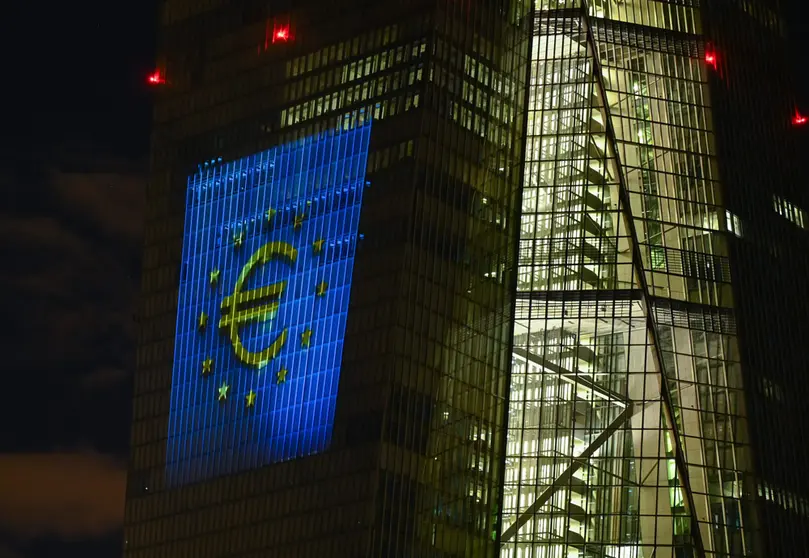 30 December 2021, Hessen, Frankfurt/Main: The European Currency "Euro" symbol is projected onto the south facade of the European Central Bank's (ECB) headquarters in Frankfurt's East End. On New Year's Eve 20 years ago, the single European currency, the euro, was introduced in twelve EU countries. Photo: Arne Dedert/dpa.