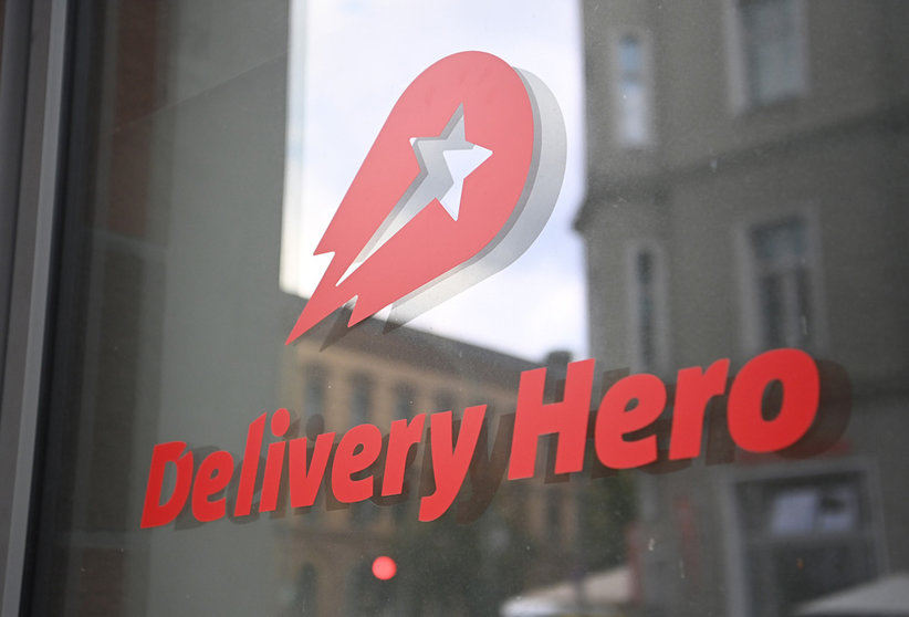 FILED - 19 August 2020, Berlin: The logo of the food delivery service Delivery Hero is seen on a glass pane at the headquarters. Delivery Hero said it was making a U-turn and suspending its food delivery service in its home market Germany, just months after returning to the country, and selling its business in Japan. Photo: Britta Pedersen/dpa-Zentralbild/dpa.