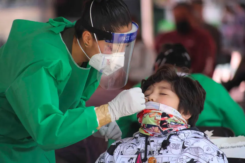 FILED - A health worker takes a swab for a coronavirus test from a child at a test centre in Toluca. Photo: -/El Universal via ZUMA Press Wire/dpa.