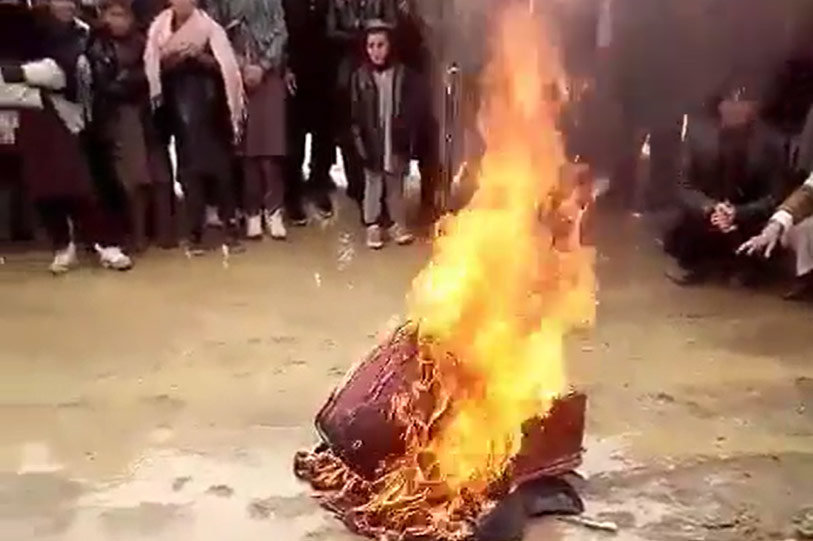 Bonfire in which musical instruments burn. Image: Twitter video screenshot.