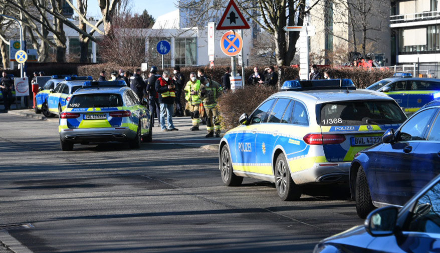 FILED - Police vehicles are parked on the grounds of Heidelberg University. According to information from dpa, there has been a rampage on the campus. A lone perpetrator used a long gun to injure several people in a lecture hall on Monday afternoon, police said. The perpetrator has since died. Photo: R.Priebe/Pr-Video/dpa.