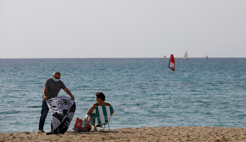 12 February 2022, Spain, Arenal: People sunbath on the beach of Arenal in Mallorca. In view of falling Corona numbers, the outdoor mask requirement ended in Spain on Feb. 10. Photo: Clara Margais/dpa.