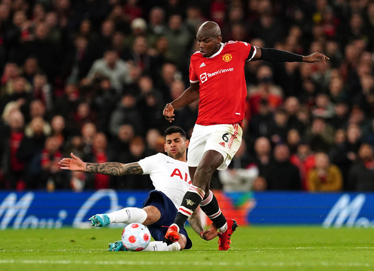 12 March 2022, United Kingdom, Manchester: Tottenham Hotspur's Cristian Romero (L) and Manchester United's Paul Pogba battle for the ball during the English Premier League soccer match between Manchester United and Tottenham Hotspur at Old Trafford. Photo: Martin Rickett/PA Wire/dpa.