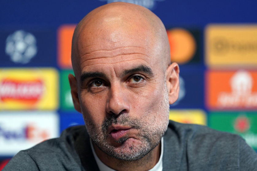 25 April 2022, United Kingdom, Manchester: Manchester City manager Pep Guardiola reacts during a press conference at the City Football Academy ahead of Tuesday's UEFA Champions League semi-final first leg soccer match against Real Madrid. Photo: Martin Rickett/PA Wire/dpa.