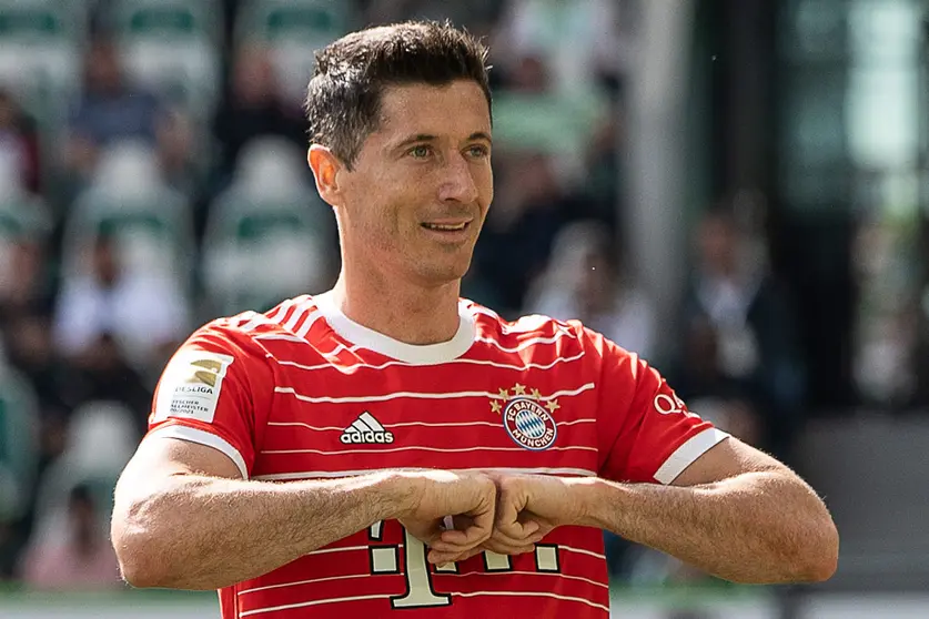 FILED - 14 May 2022, Lower Saxony, Wolfsburg: Munich's Robert Lewandowski celebrates scoring his side's second goal during the German Bundesliga soccer match between VfL Wolfsburg and Bayern Munich at Volkswagen Arena. Barcelona have made a first written transfer bid of €32 million ($33.8 million) for Bayern Munich striker Robert Lewandowski, according to a report on Sunday. Photo: Swen Pförtner/dpa.