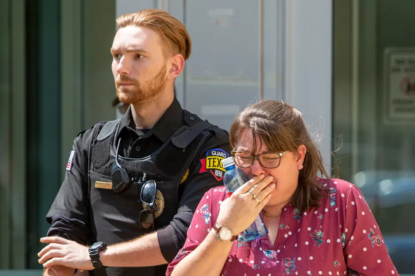 24 May 2022, US, Uvalde: A woman burst into tears as she leaves the Uvalde Civic Center. Fourteen students and one teacher were killed in a shooting in an elementary school in the small town of Uvalde Governor Greg Abbott has said in a press conference. Photo: San Antonio Express-News/SanAntonio Express-News via ZUMA/dpa.