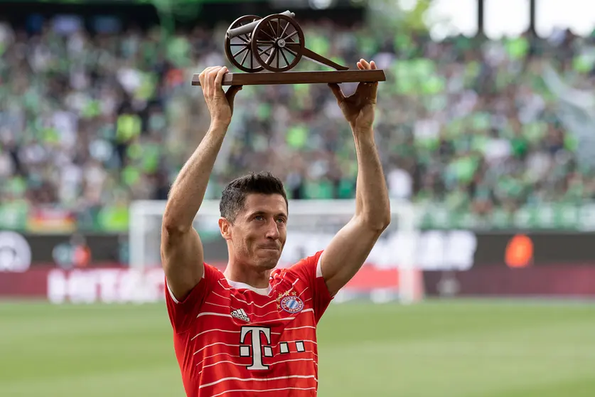 FILED - 14 May 2022, Lower Saxony, Wolfsburg: Bayern Munich's Robert Lewandowski holds up the Kicker scoring canon as top scorer after the German Bundesliga soccer match between VfL Wolfsburg and Bayern Munich at Volkswagen Arena. arcelona have made a first written transfer bid of 32 million euros (33.8 million dollars) for Bayern Munich striker Robert Lewandowski, according to a report on Sunday. Photo: Swen Pförtner/dpa.