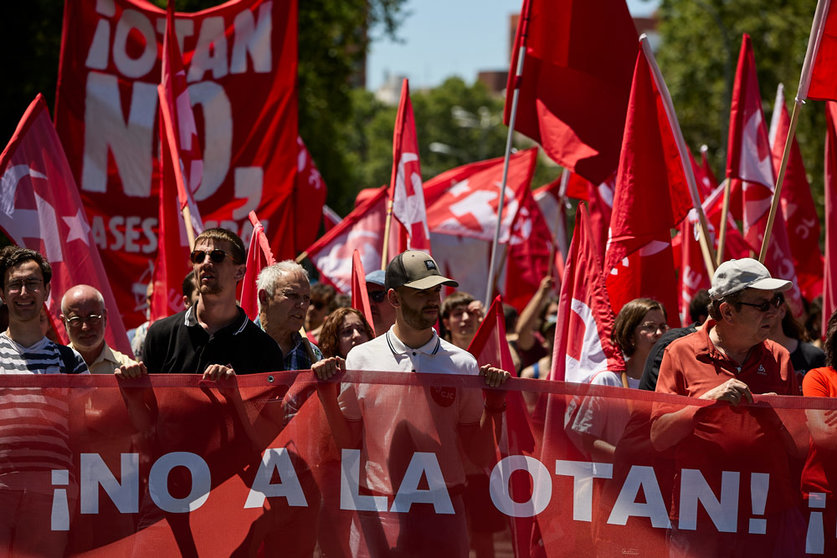 26 June 2022, Spain, Madrid: People hold flags of the Communist Party of the Workers of Spain (PCTE) during a protest against the NATO Summit, which will be held on 29-30 June in Madrid. Photo: Jesús Hellín/EUROPA PRESS/dpa.