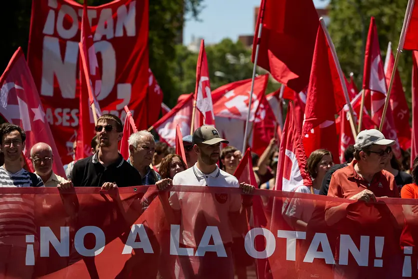 26 June 2022, Spain, Madrid: People hold flags of the Communist Party of the Workers of Spain (PCTE) during a protest against the NATO Summit, which will be held on 29-30 June in Madrid. Photo: Jesús Hellín/EUROPA PRESS/dpa.